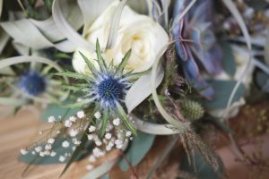 Close up of thistle in bouquet | Journey to the Centre of the Earth | modern ethereal winter styled bridal shoot by Hanami Dream | agate | marble | airplants | tulle | pale blue | gold | Oxleaze Barn | Gloucestershire | October 2017 | Photography by Squib Photography www.squibphotography.co.uk