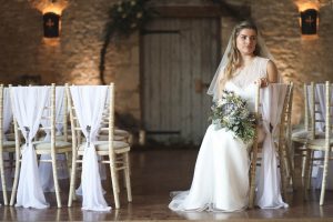 Bride sat on Chivari chair in front of moongate wreath | Journey to the Centre of the Earth | modern ethereal winter styled bridal shoot by Hanami Dream | agate | marble | airplants | tulle | pale blue | gold | Oxleaze Barn | Gloucestershire | October 2017 | Photography by Squib Photography www.squibphotography.co.uk