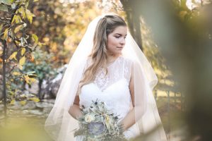 Bride under blurry tree | Journey to the Centre of the Earth | modern ethereal winter styled bridal shoot by Hanami Dream | agate | marble | airplants | tulle | pale blue | gold | Oxleaze Barn | Gloucestershire | October 2017 | Photography by Squib Photography www.squibphotography.co.uk